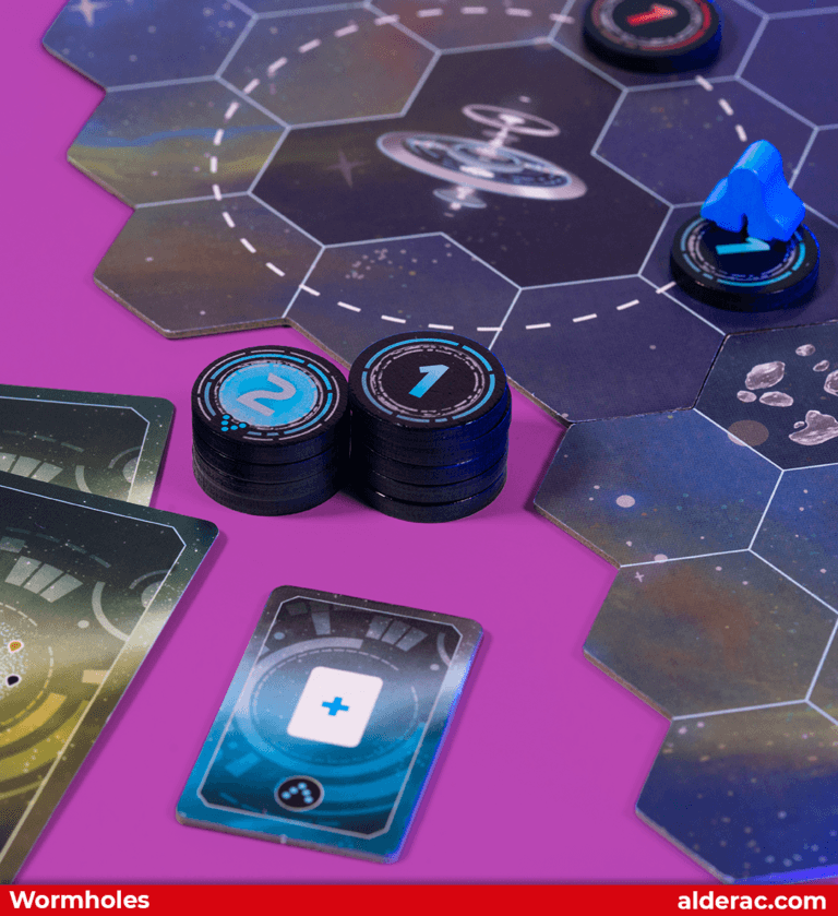 a close up to a pleyrs tokens of wormholes with a section of the game board