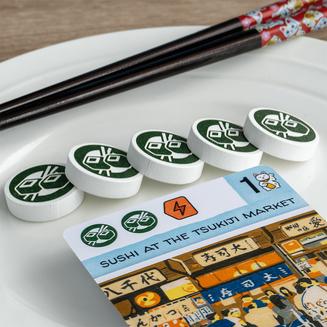 Let's go! To Japan sushi bar card with sushi activity tokens and chopsticks.